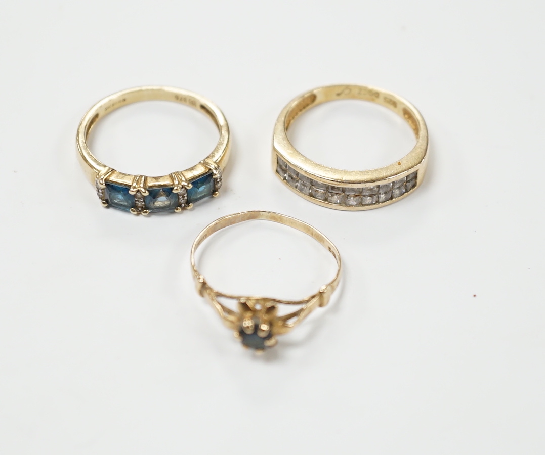 Two 9ct gold dress rings, one set with sapphire and diamonds, the other a single sapphire, and a diamond chip set ring, stamped 925, size M